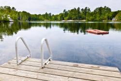 Dock with metal ladder in front of calm lake