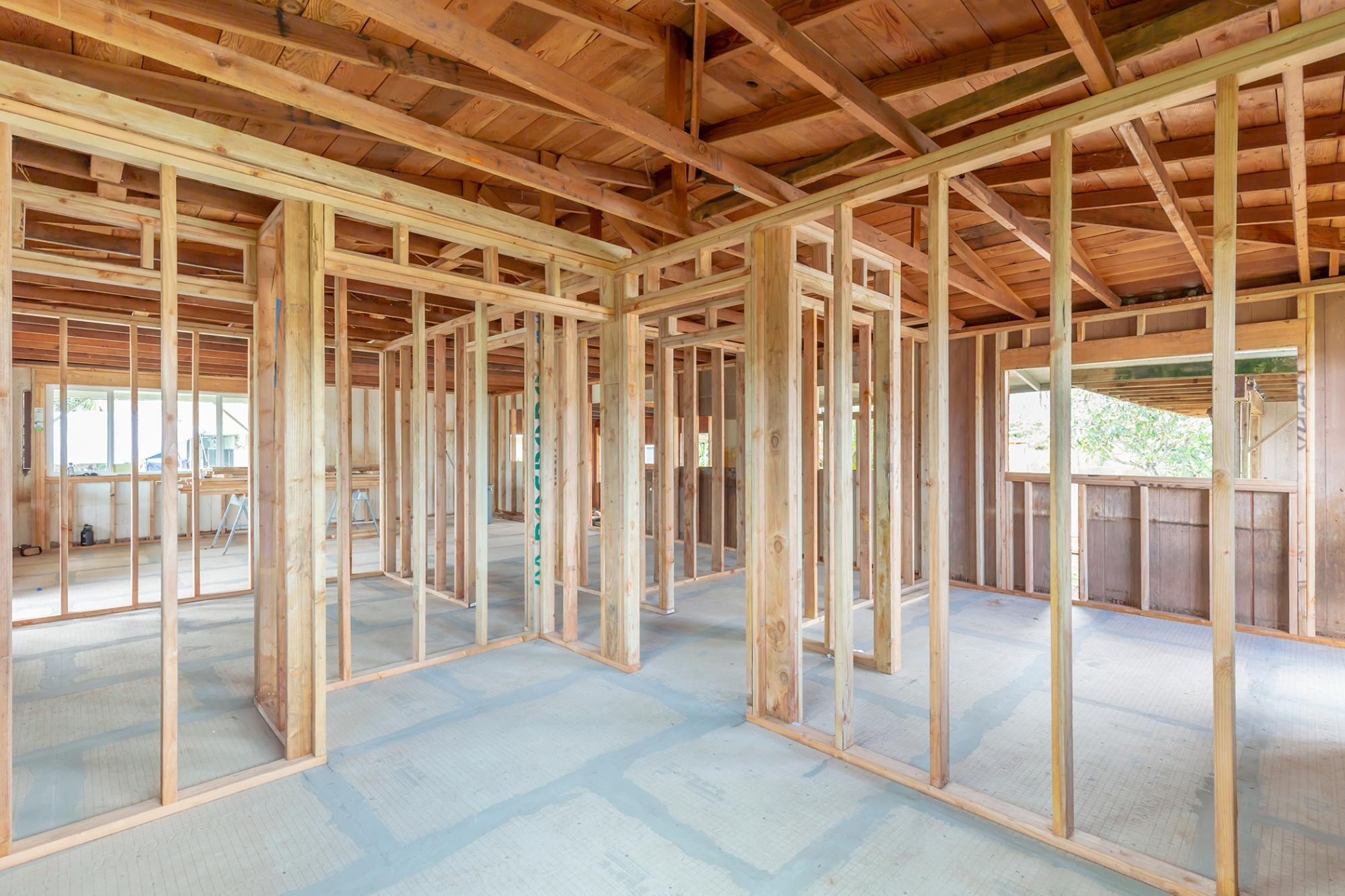Interior of construction of a home with wood framing and concrete floors 