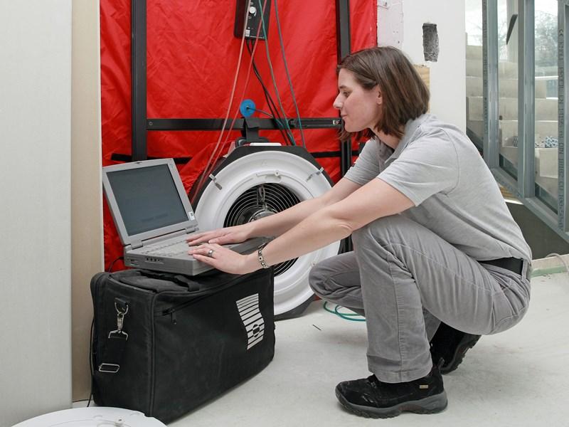 lady performing blower door test